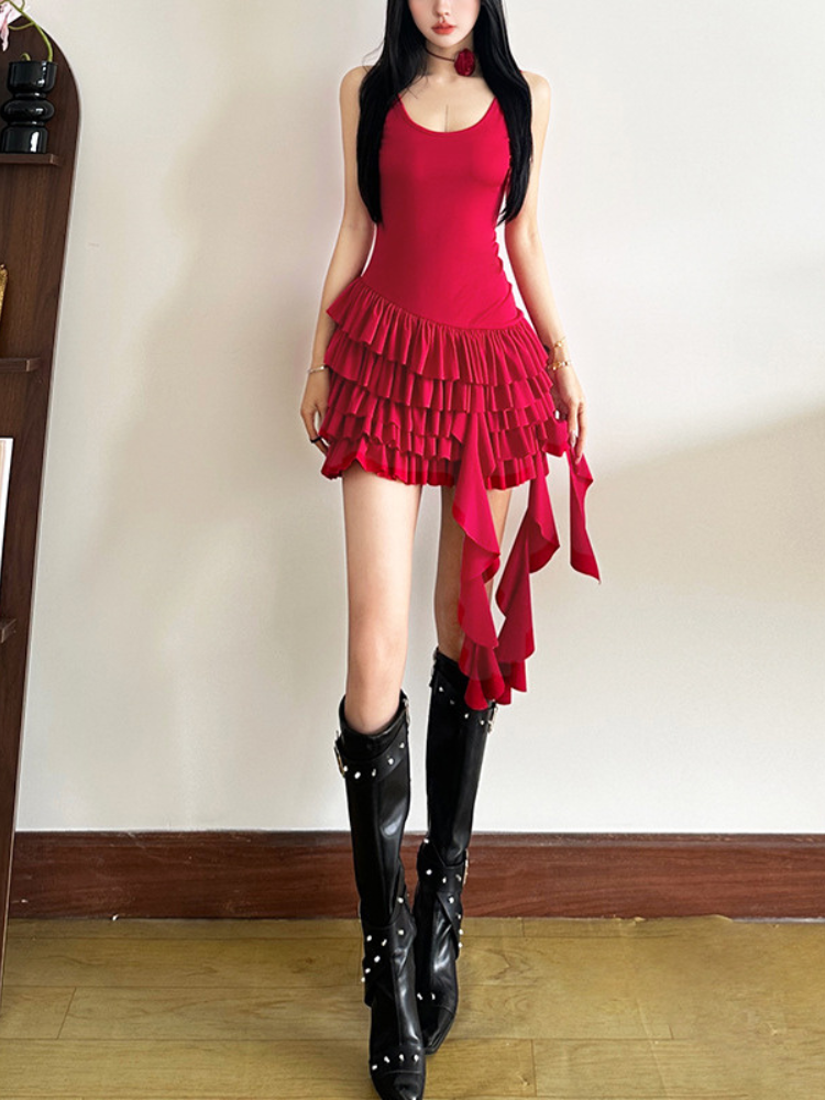 Model showcasing the back of a red sleeveless mini dress with layered ruffles and an asymmetrical hem.