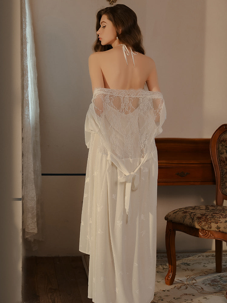 Bsck view of a woman standing in butterfly print white halter dress with lace robe