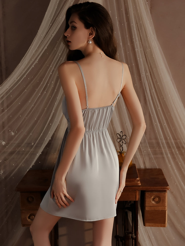 Back view of a light blue satin babydoll dress with an elastic back design, highlighting the simplicity and flow of the dress.