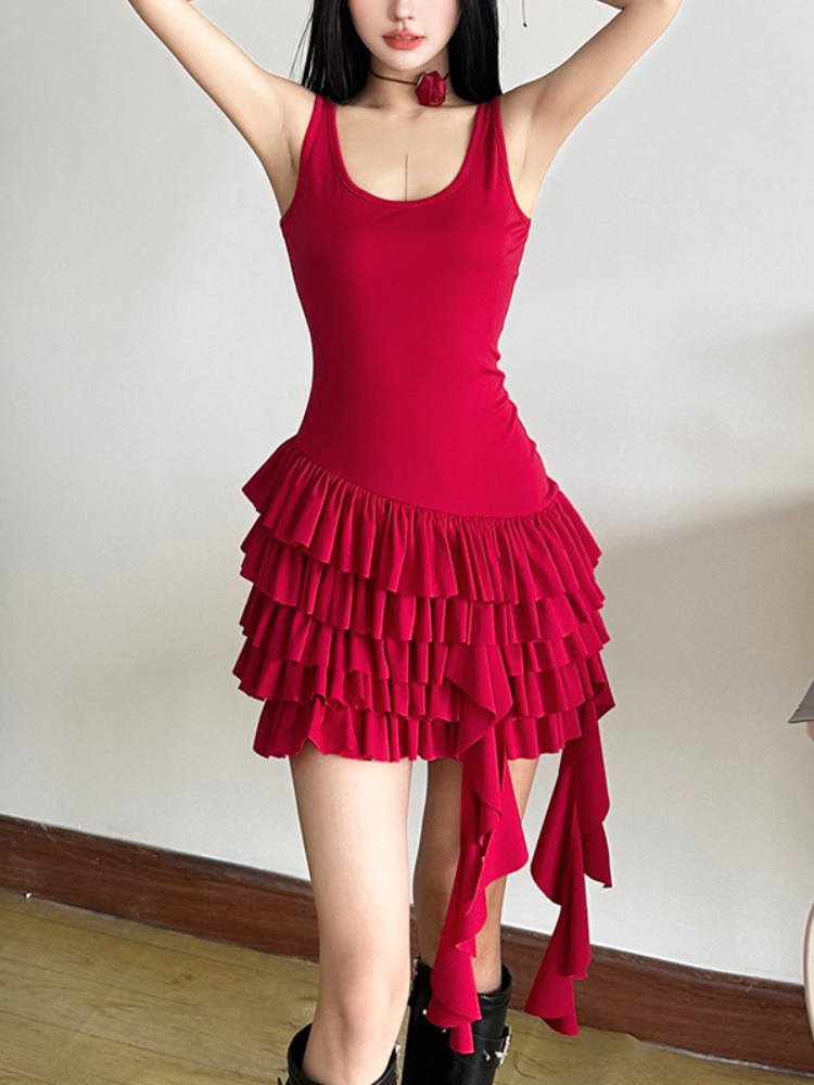 Red sleeveless mini dress with scoop neckline, layered ruffles, and asymmetrical hem, styled for a chic look.