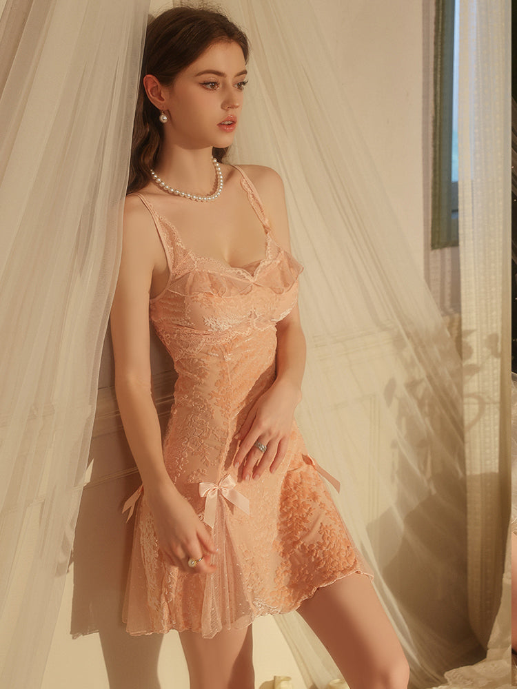 Woman wearing pink Velvet Floral Satin Slip Dress with Lace and Bow Details with a soft, blurred background