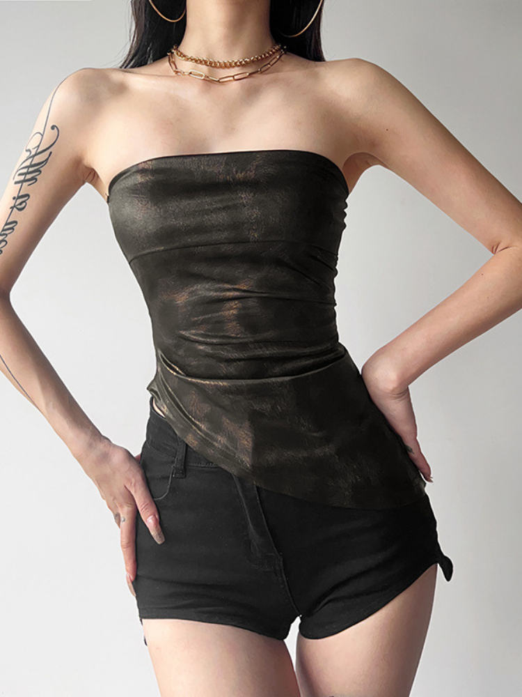 Person wearing a black strapless top and shorts on a plain background