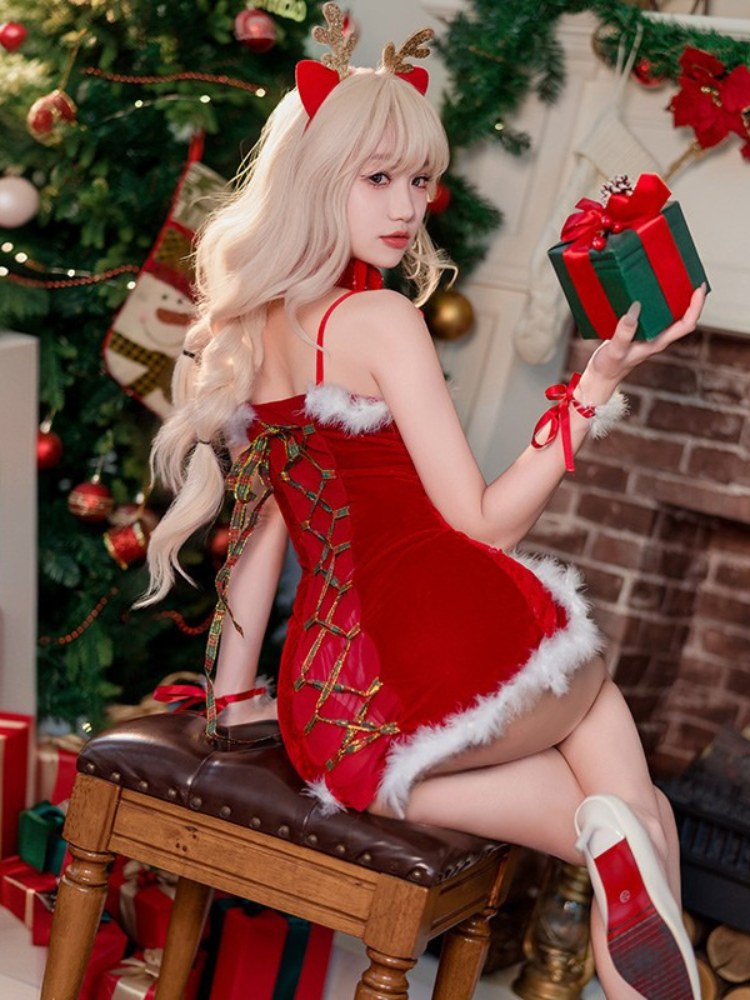 Woman in Red Christmas Cutout Bodycon Mini Dress Lingerie Set with Fur Trim holding a gift box in a decorated Christmas setting