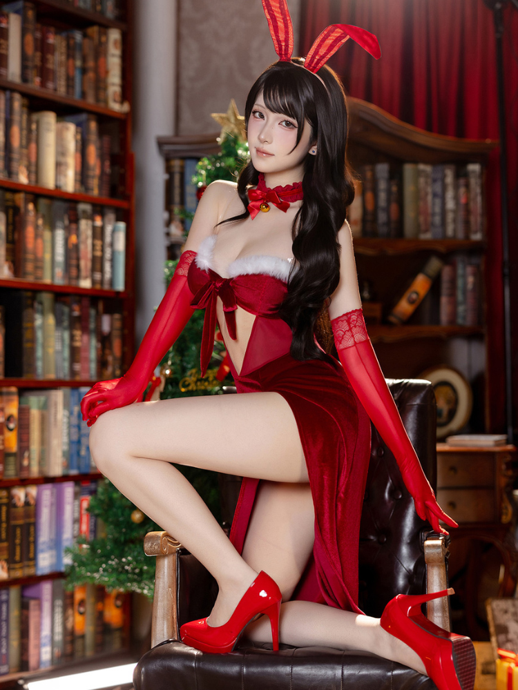 Woman in a red bunny costume sitting on a chair in a room with bookshelves. Red Velvet Christmas Dress Bunny Lingerie Set with Cutout Maxi Slip