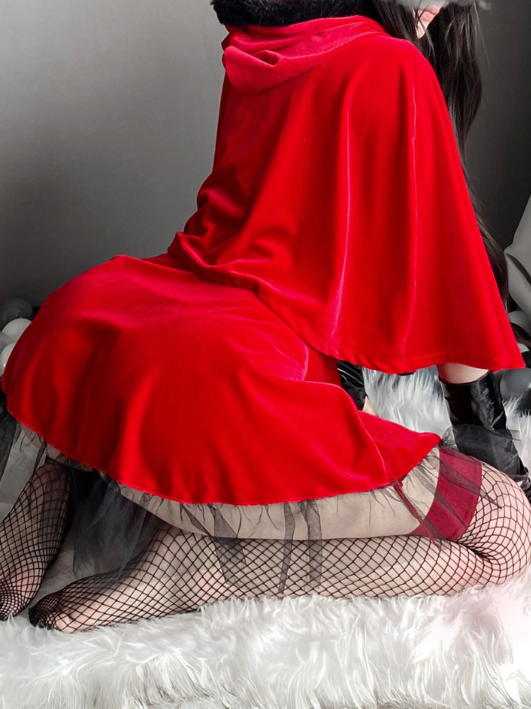 Back view of a red cape costume dress with tulle skirt layers, styled with a holiday-inspired outfit for Christmas events