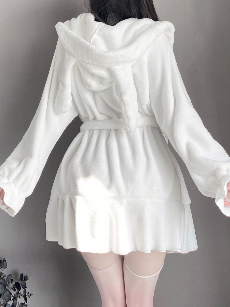 Rear view of a white fluffy robe with a bunny ear hood, highlighting its cozy and playful design.