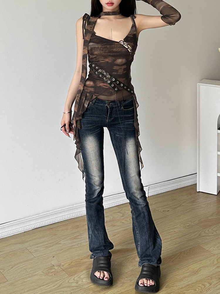 Person wearing a brown sleeveless top with lace-up details and blue jeans indoors.
