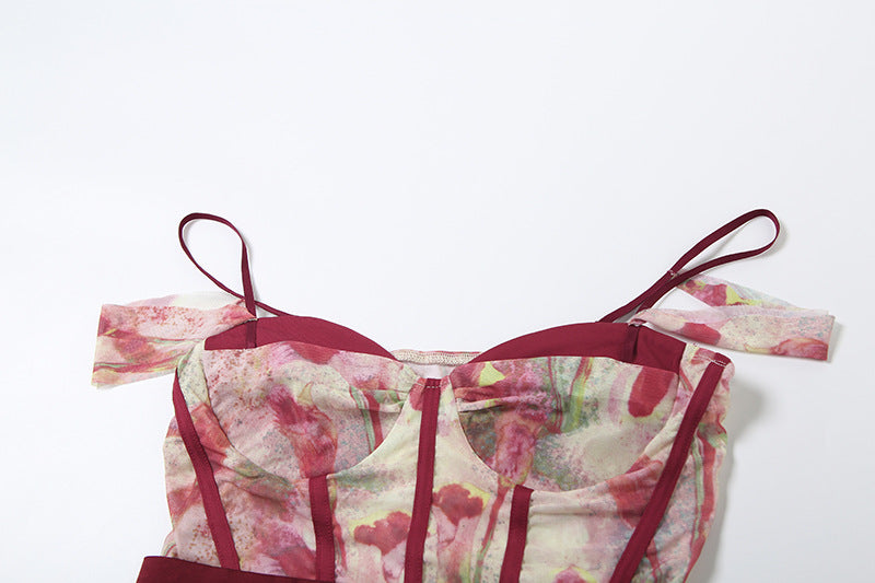 Floral patterned top with thin straps on a white background