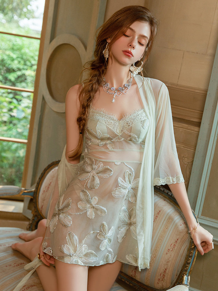 Woman in a Sheer Floral Embroidered Mint Green Mini Dress sitting on a decorative chair with a blurred background