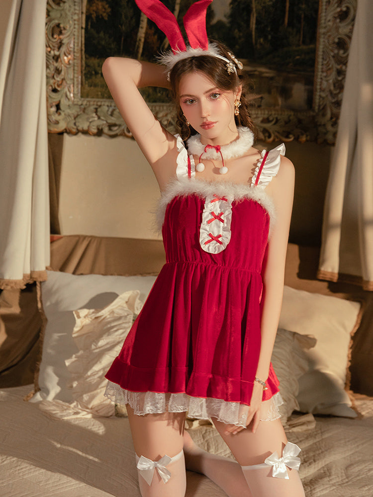 Woman in a Red Velvet Bunny Christmas Babydoll Lingerie Mini Dress with white fur trim in a decorated room.