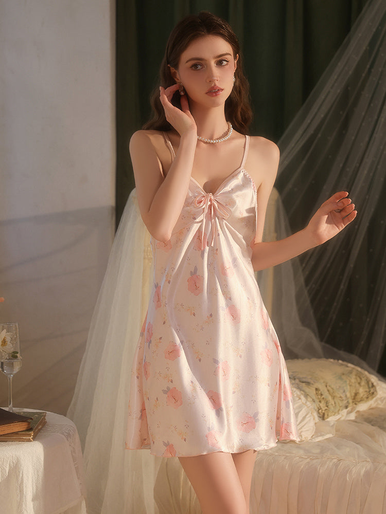 Woman wearing a floral nightgown in a softly lit room.
