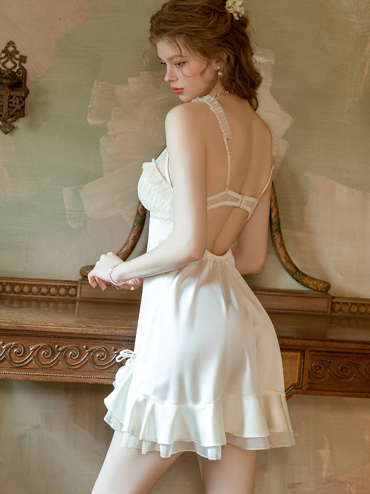 Woman in a white lace nightgown standing in a vintage room. satin mini dress, slip dress, babydoll dress, white slip dress, open back dress, ruffle mini dress, lace trim sleep dress.