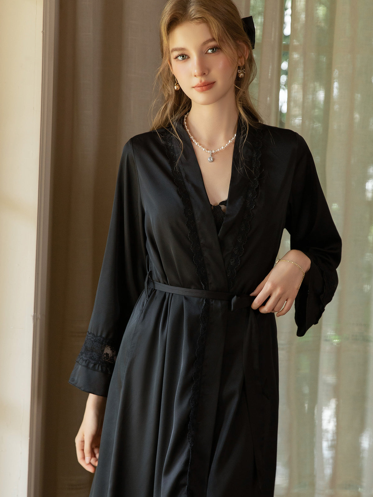 Black satin robe front view showing lace trim, wide sleeves and tie belt over the separately sold dress