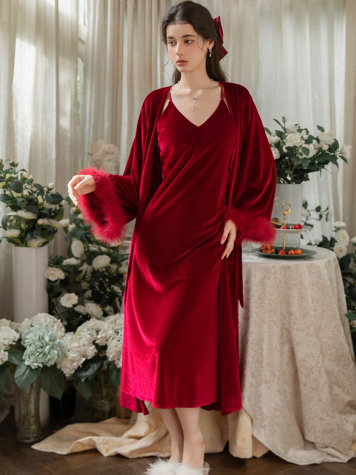 Red plush cuff velvet wrap robe worn open over coordinating midi slip dress