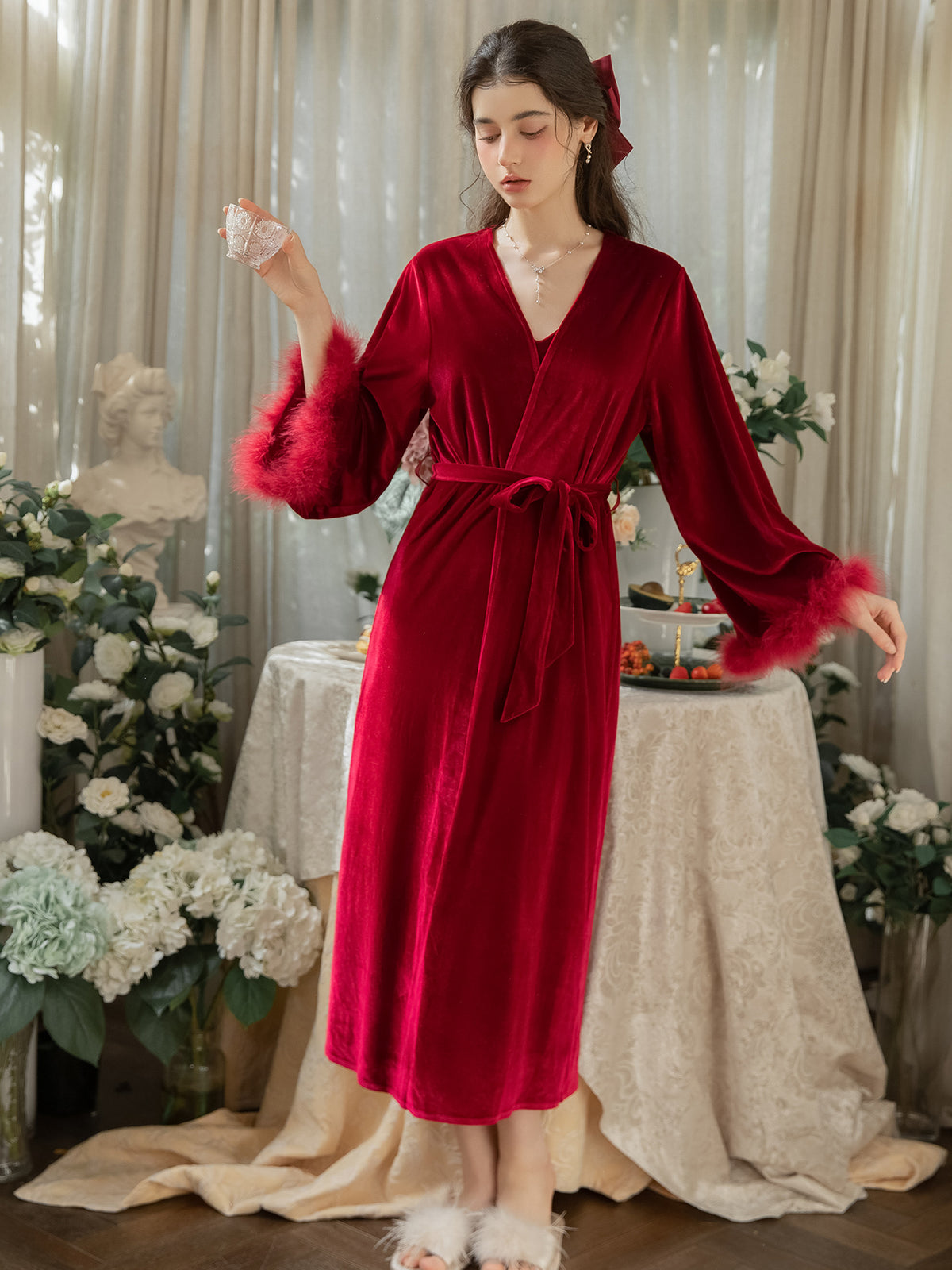 Red velvet midi wrap robe tied at the waist showing plush cuffs